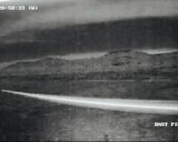 contrail of a orb as it flies past a security camera on the ranch